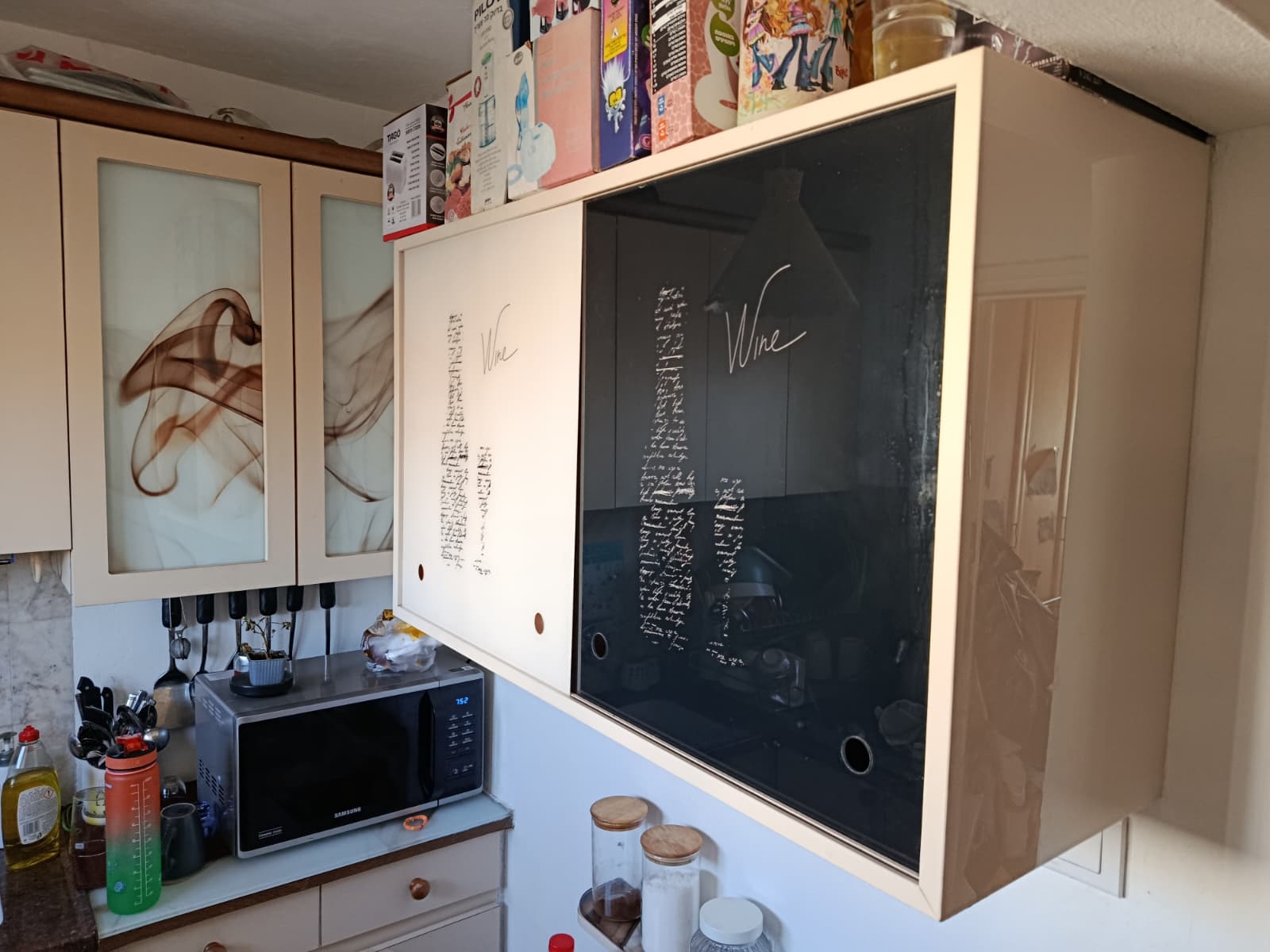 Artistic lettering applied to a cupboard front.